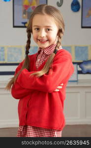 Portrait Of Female Primary School Pupil Standing In Classroom