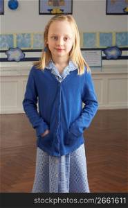 Portrait Of Female Primary School Pupil Standing In Classroom