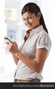 Portrait of female professional text messaging on cell phone