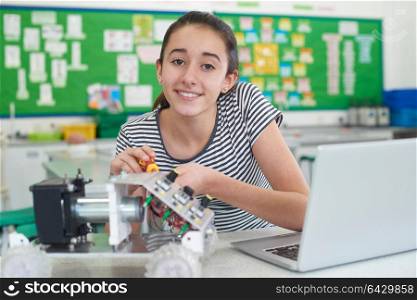 Portrait Of Female Pupil Studying Robotics In Science Lesson