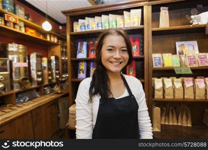 Portrait of female salesperson smiling in coffee shop