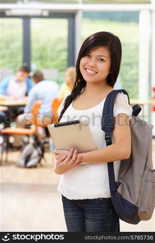 Portrait Of Female Student In Classroom With Digital Tablet