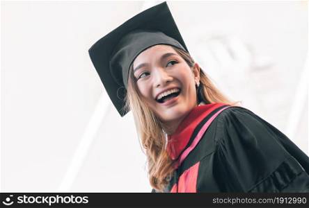Portrait of female student wearing uniform and cap of graduation. She smiling with success, happiness and proud. Education Concept.
