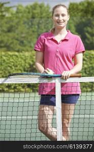 Portrait Of Female Tennis Coach On Court