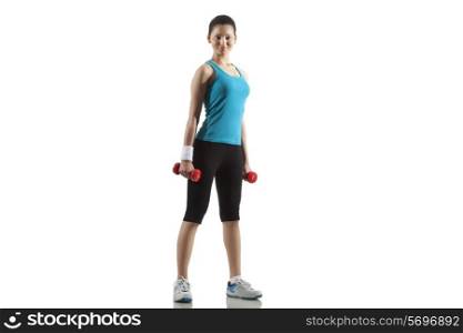 Portrait of fit young woman exercising with dumbbells isolated over white background