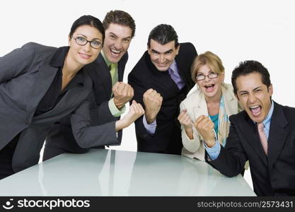 Portrait of five business executives cheering