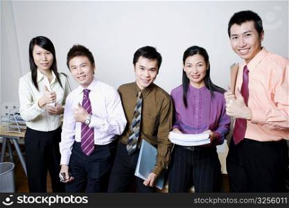 Portrait of five business executives standing and smiling together