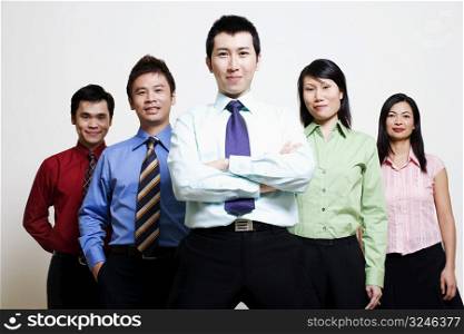 Portrait of five business executives standing together and smiling
