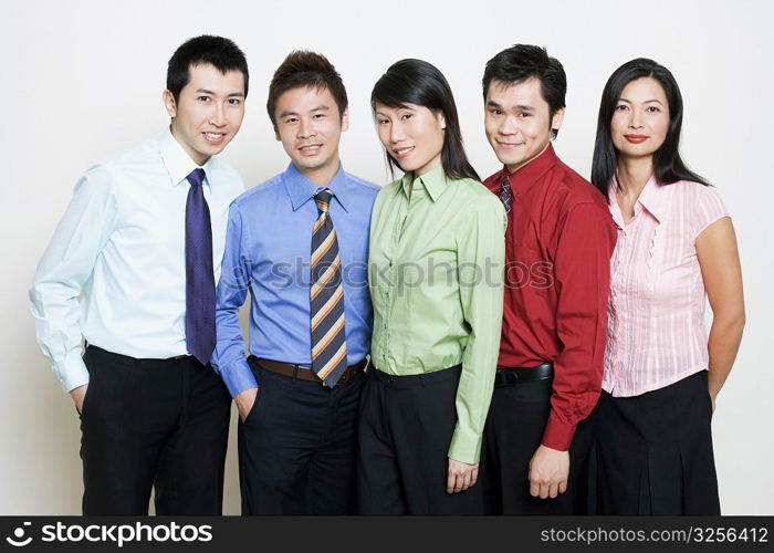 Portrait of five business executives standing together and smiling