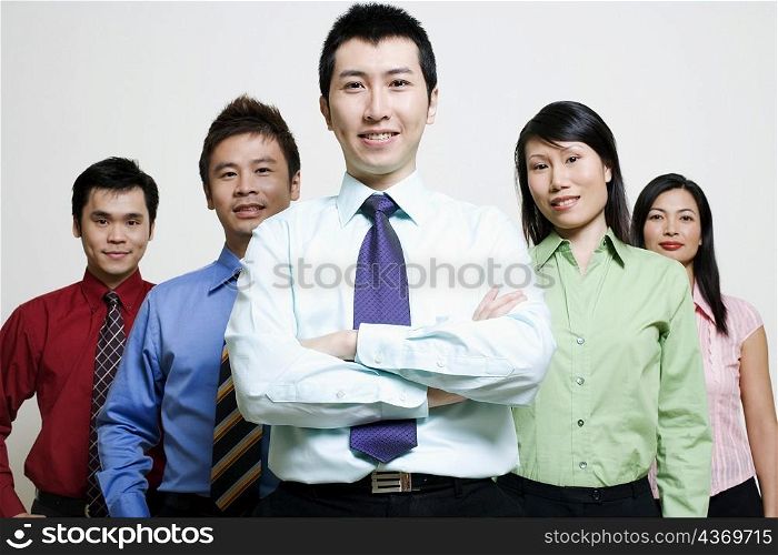 Portrait of five business executives standing together and smiling