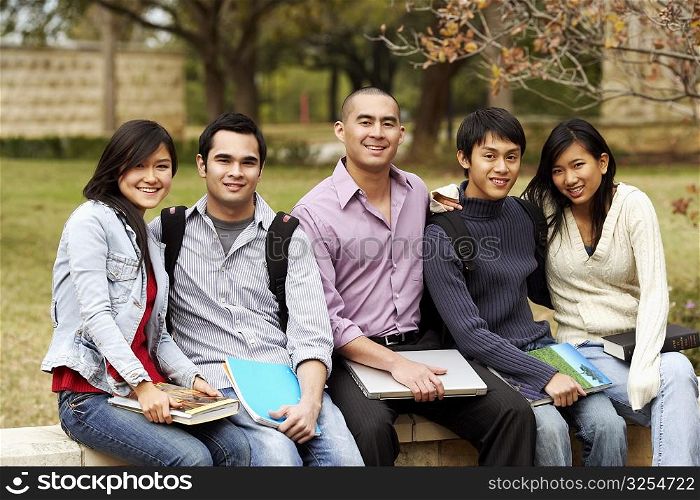 Portrait of five college students sitting together in a college campus