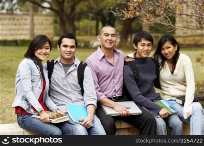 Portrait of five college students sitting together in a college campus