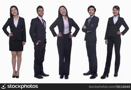 Portrait of five young smiling businesswomen and young businessmen, looking at camera, studio shot