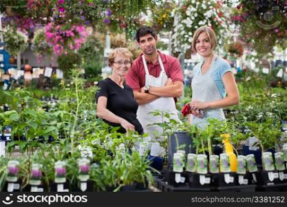 Portrait of florists standing with female customer