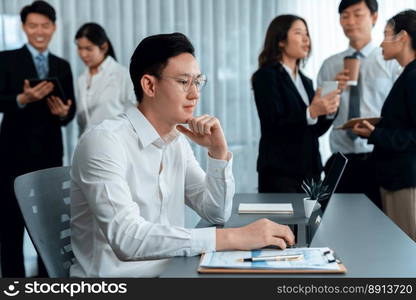 Portrait of focus young successful confident male manager, executive wearing business wear in harmony office arm crossed with blurred meeting background of colleagues, office worker.. Portrait of focus successful confident male manager in harmony office.