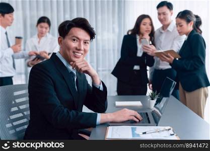 Portrait of focus young successful confident male manager, executive wearing business wear in harmony office arm crossed with blurred meeting background of colleagues, office worker.. Portrait of focus successful confident male manager in harmony office.