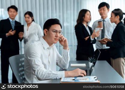 Portrait of focus young successful confident male manager, executive wearing business wear in harmony office arm crossed with blurred meeting background of colleagues, office worker.. Portrait of focus successful confident male manager in harmony office.