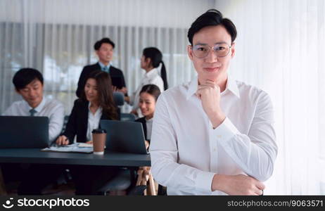 Portrait of focus young successful confident male manager, executive wearing business wear in harmony office arm crossed with blurred meeting background of colleagues, office worker.. Portrait of focus successful confident male manager in harmony office.