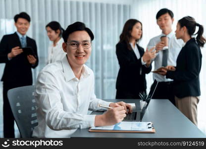 Portrait of focus young successful confident male manager, executive wearing business wear in harmony office arm crossed with blurred meeting background of colleagues, office worker.. Portrait of focus successful confident male manager in harmony office.