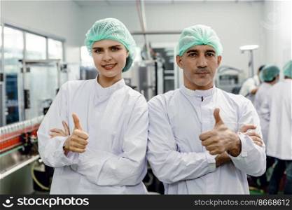 Portrait of food factory worker male and female thumbs up happy enjoy working with clean hygiene dressing. good quality products guarantee concept.