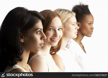 Portrait Of Four Attractive Young Women In Studio Standing In Line