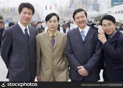 Portrait of four businessmen standing together