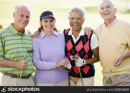 Portrait Of Four Friends Enjoying A Game Golf