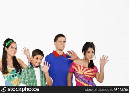 Portrait of four people waving their hands
