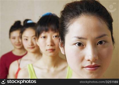 Portrait of four young women in a row