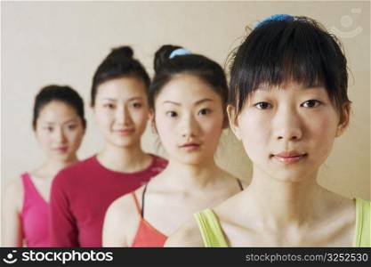 Portrait of four young women in a row