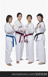 Portrait of four young women in fighting stance