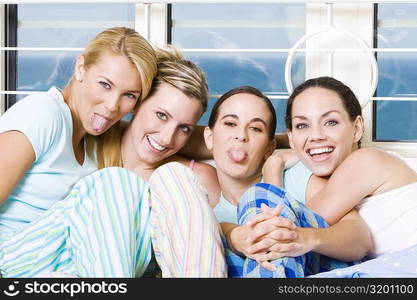 Portrait of four young women sitting on a couch