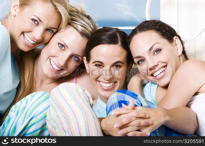 Portrait of four young women smiling