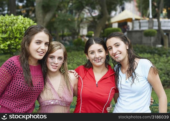 Portrait of four young women standing together and smiling