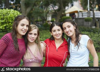 Portrait of four young women standing together and smiling