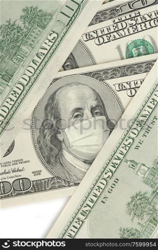 Portrait of Franklin on 100 dollar banknote with medical mask. The concept of coronavrius epidemic and the financial crisis caused by this collapse. Portrait of Franklin on 100 dollar banknote with medical mask