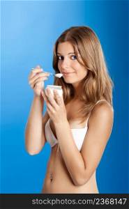 Portrait of Fresh and Beautiful young woman eating a yogurt