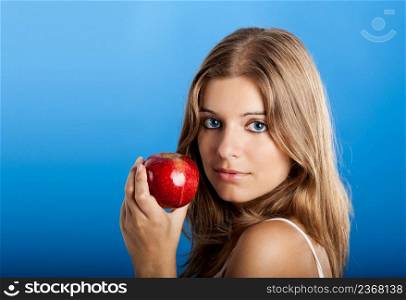 Portrait of Fresh and Beautiful young woman holding a red apple