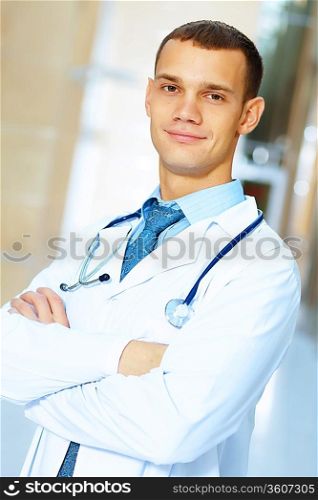 Portrait of friendly male doctor in hospital smiling