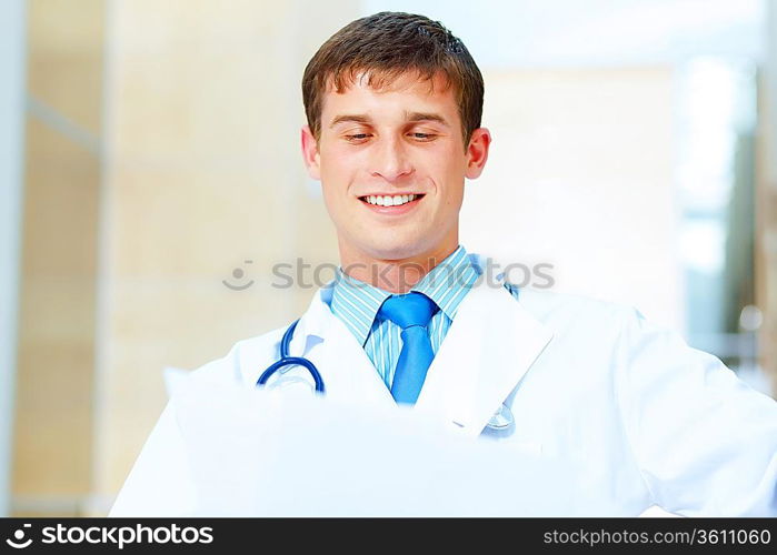 Portrait of friendly male doctor in hospital smiling