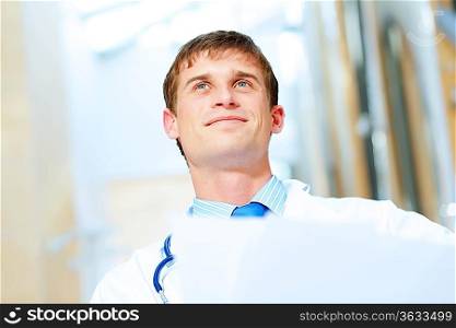 Portrait of friendly male doctor in hospital smiling