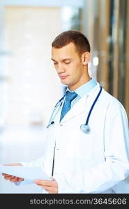 Portrait of friendly male doctor in hospital smiling