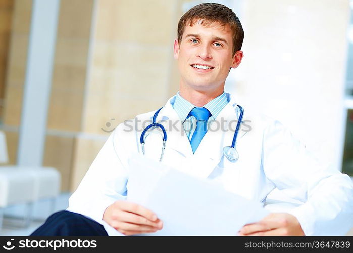 Portrait of friendly male doctor in hospital smiling