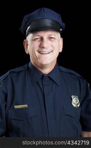Portrait of friendly, smiling police officer on black background.