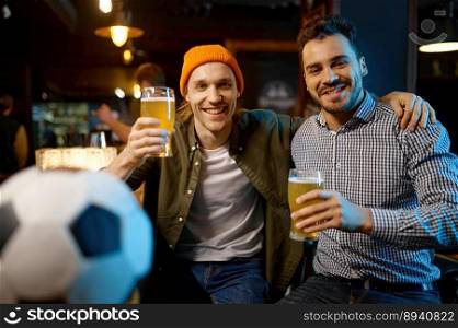 Portrait of friends football fans embracing and looking at camera. Young people drinking beer while watching soccer match ch&ionship in sports bar. Portrait of friends football fans embracing and looking at camera