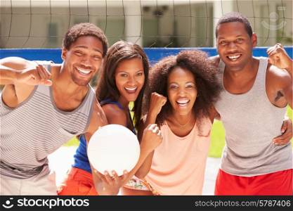 Portrait Of Friends Playing Volleyball Match