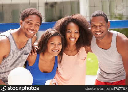 Portrait Of Friends Playing Volleyball Match