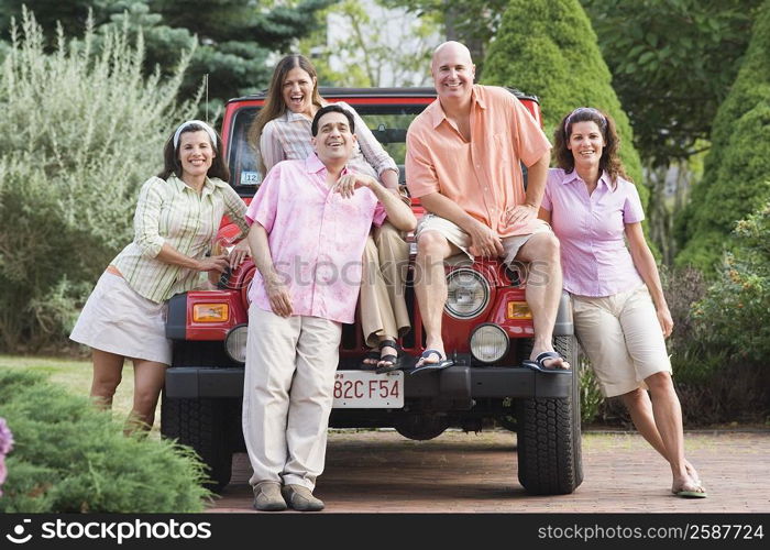 Portrait of friends smiling on a car