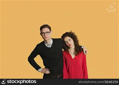Portrait of friends standing together over colored background