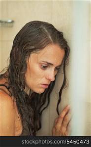 Portrait of frustrated young woman in shower